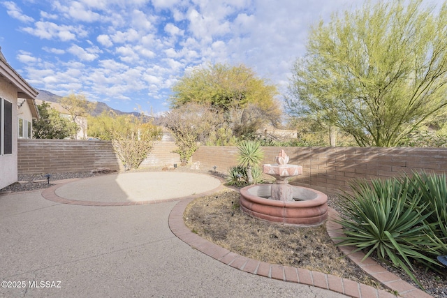 view of yard featuring a mountain view and a patio