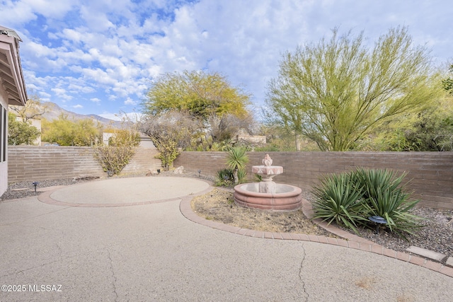 view of yard featuring a mountain view and a patio area