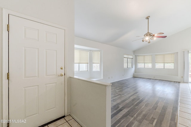 entryway with hardwood / wood-style flooring, vaulted ceiling, and ceiling fan