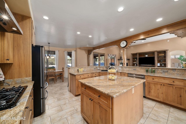 kitchen featuring extractor fan, light stone counters, a center island, appliances with stainless steel finishes, and kitchen peninsula