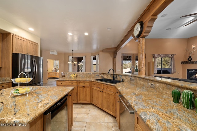 kitchen featuring dishwasher, sink, a large island, light stone countertops, and fridge with ice dispenser