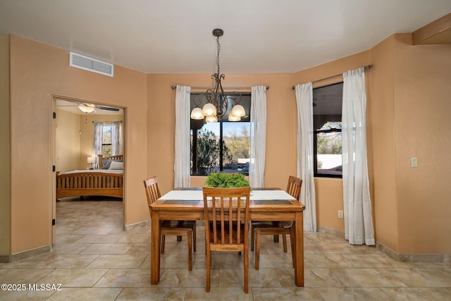 dining space featuring a notable chandelier and a wealth of natural light