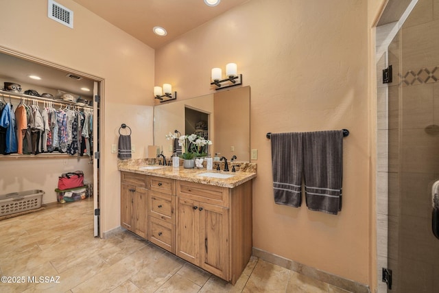 bathroom with vanity and an enclosed shower