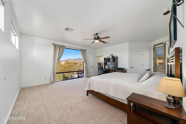 carpeted bedroom with multiple windows, access to exterior, and ceiling fan