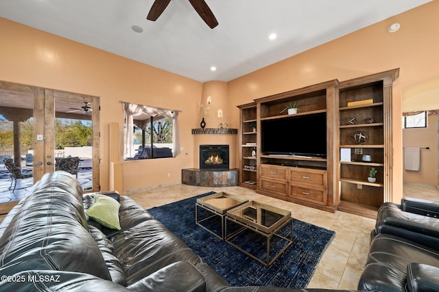 tiled living room featuring ceiling fan, plenty of natural light, and a fireplace