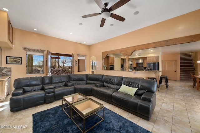 tiled living room featuring ceiling fan