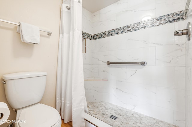 bathroom featuring curtained shower and toilet