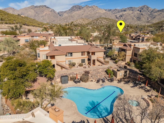 view of pool with a mountain view and a patio