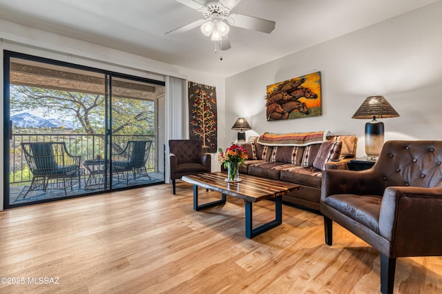 living room featuring ceiling fan and light wood-type flooring