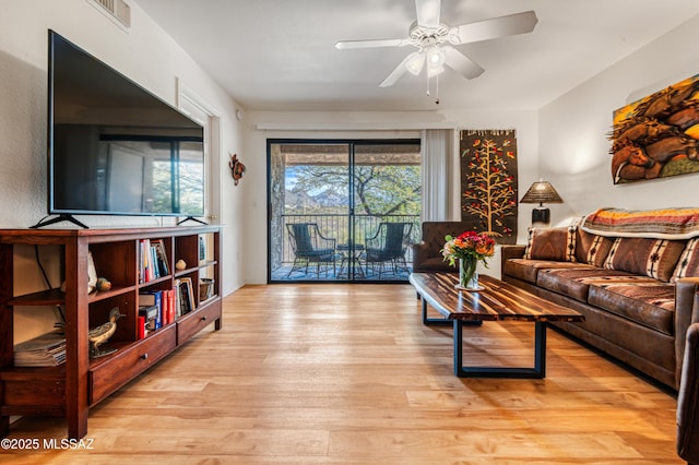 living room featuring ceiling fan and light wood-type flooring