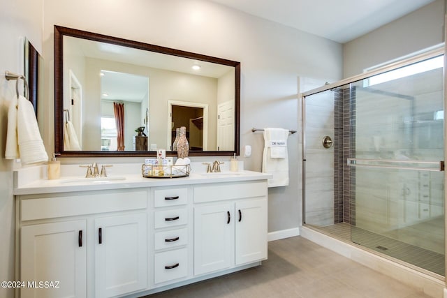 bathroom featuring vanity, a healthy amount of sunlight, and an enclosed shower