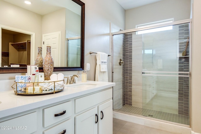 bathroom with vanity, an enclosed shower, and tile patterned flooring