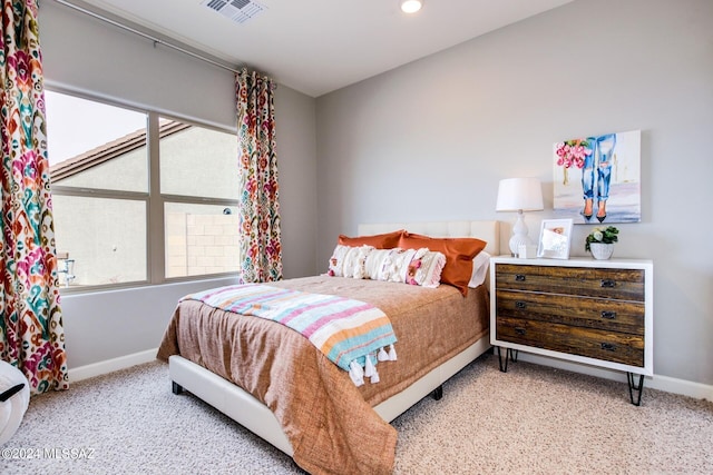 carpeted bedroom with multiple windows