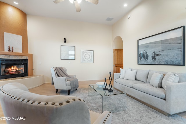 living room with ceiling fan and light wood-type flooring