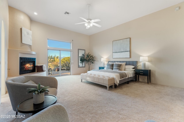 bedroom featuring access to outside, light colored carpet, and ceiling fan