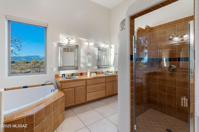 bathroom featuring tile patterned flooring, vanity, and separate shower and tub