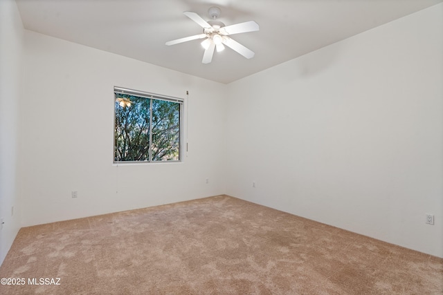 empty room featuring light colored carpet and ceiling fan