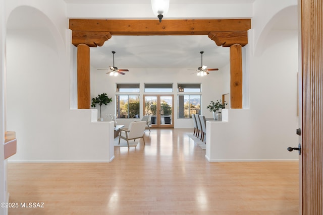 interior space featuring beam ceiling and light hardwood / wood-style floors