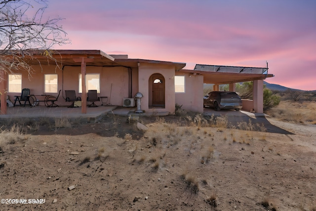 view of front of property featuring a carport