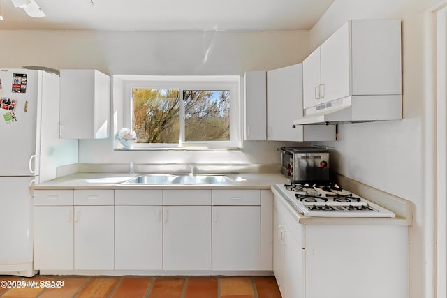 kitchen featuring white cabinetry, white appliances, and sink