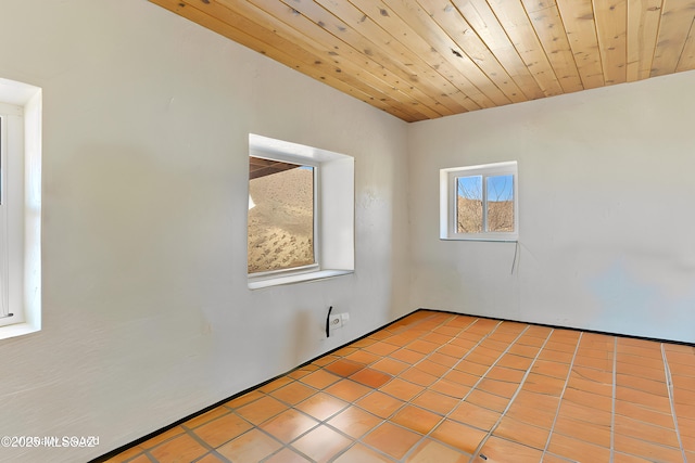 tiled spare room with wooden ceiling