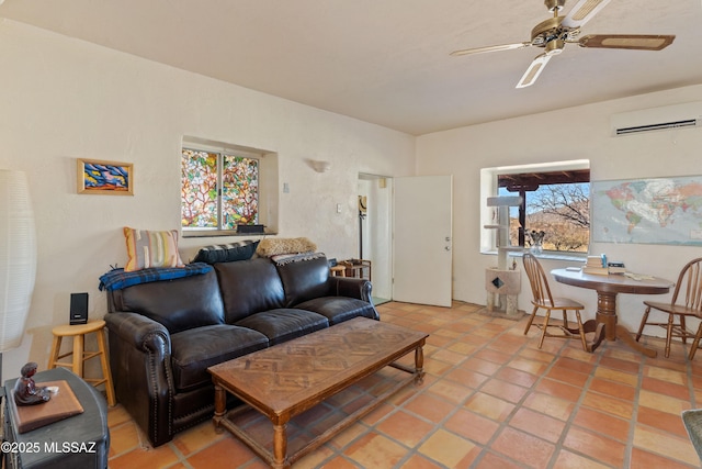 living room with ceiling fan, light tile patterned floors, an AC wall unit, and a healthy amount of sunlight