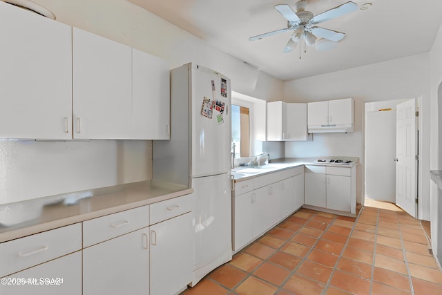 kitchen featuring sink, white cabinetry, white refrigerator, gas cooktop, and ceiling fan