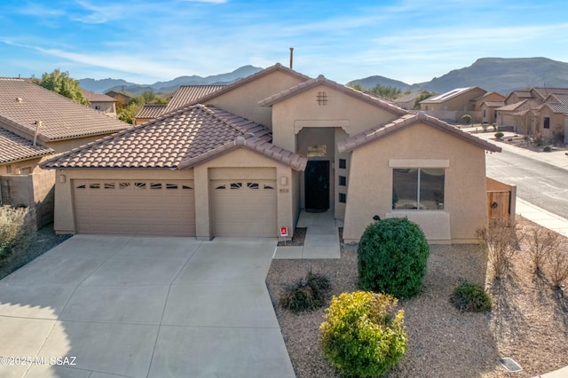 view of front of home with a mountain view and a garage