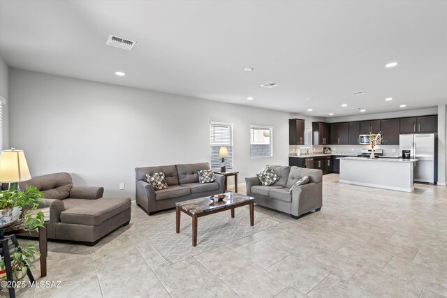 living room with recessed lighting, visible vents, baseboards, and light tile patterned floors