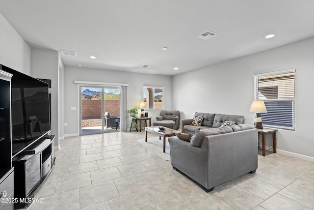 living area featuring visible vents, baseboards, recessed lighting, and light tile patterned floors