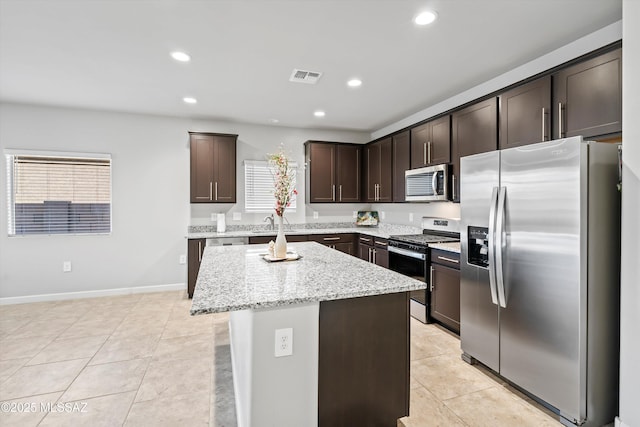 kitchen featuring visible vents, recessed lighting, stainless steel appliances, dark brown cabinetry, and light tile patterned floors