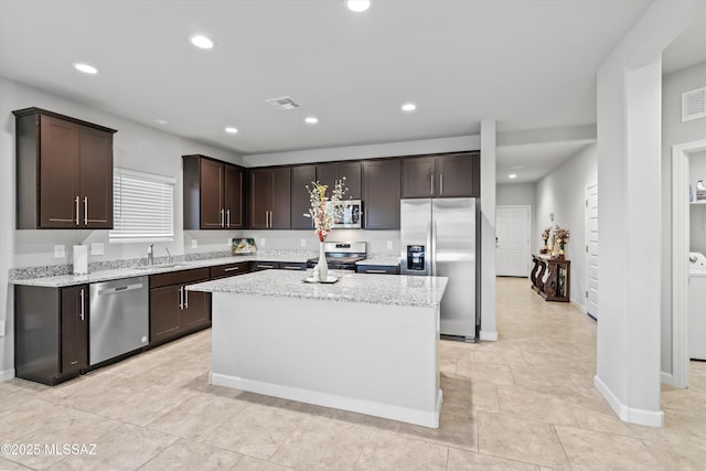 kitchen featuring dark brown cabinetry, recessed lighting, visible vents, appliances with stainless steel finishes, and a sink
