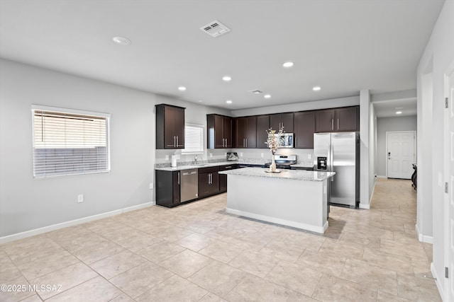 kitchen with visible vents, baseboards, appliances with stainless steel finishes, dark brown cabinetry, and recessed lighting