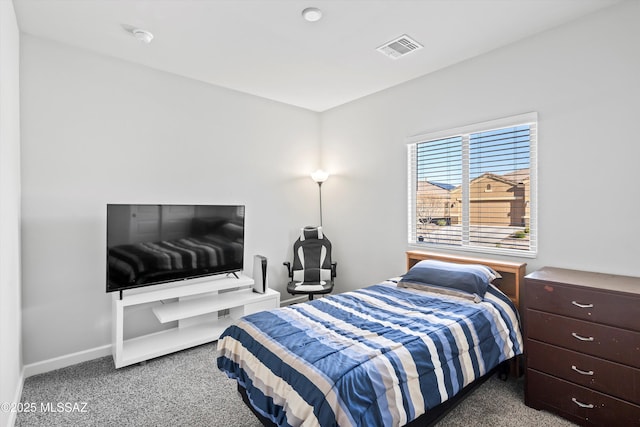 bedroom featuring visible vents, baseboards, and carpet