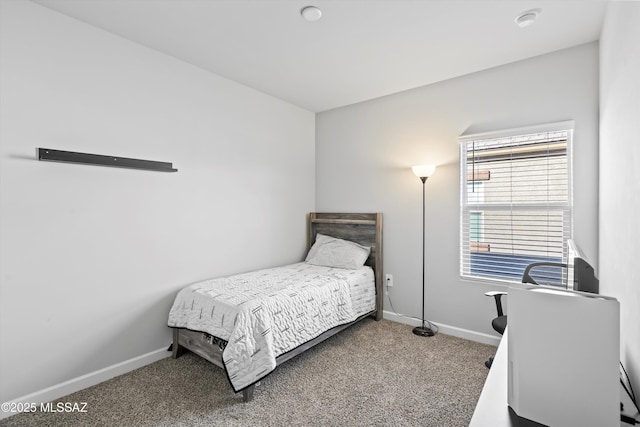 bedroom with carpet flooring and baseboards