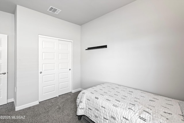 bedroom featuring a closet, baseboards, visible vents, and dark colored carpet