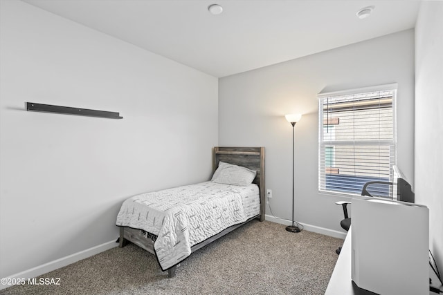carpeted bedroom featuring baseboards