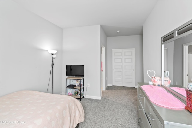 carpeted bedroom featuring baseboards