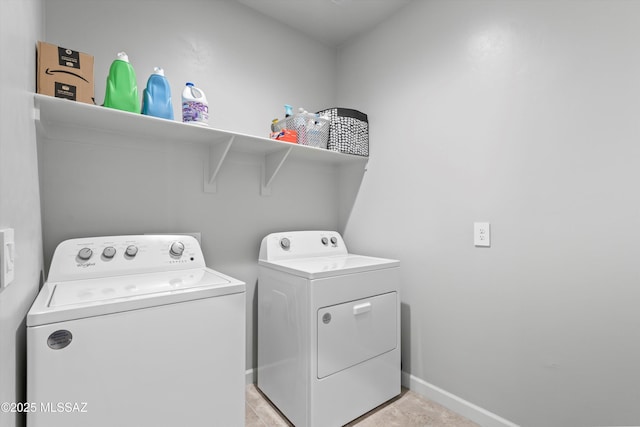 clothes washing area featuring laundry area, washing machine and dryer, and baseboards