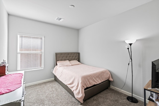 carpeted bedroom featuring baseboards and visible vents