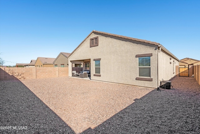 rear view of property featuring a patio area, a fenced backyard, cooling unit, and stucco siding