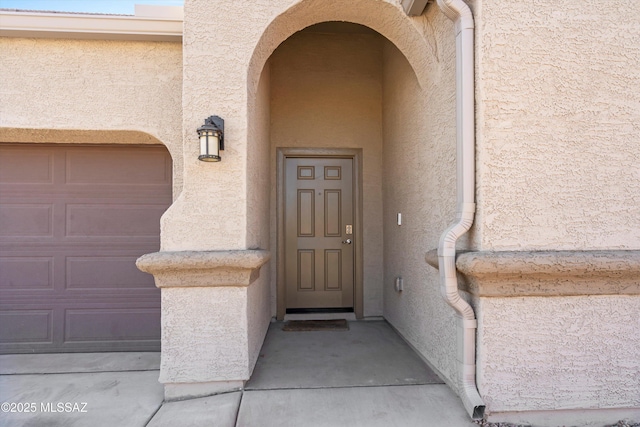 view of exterior entry with stucco siding