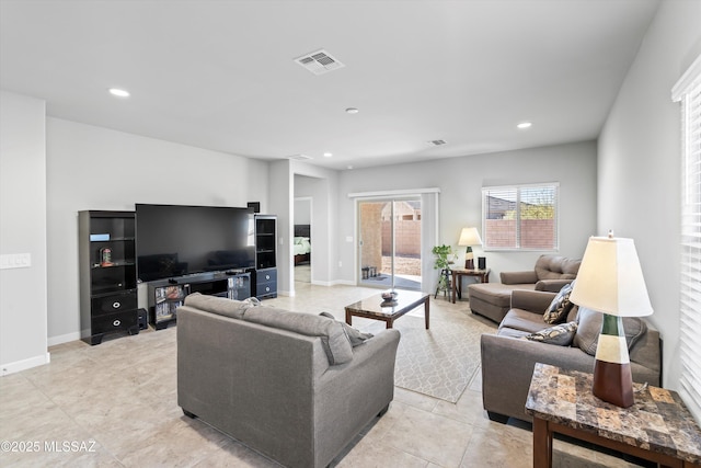 living room featuring light tile patterned floors, recessed lighting, visible vents, and baseboards