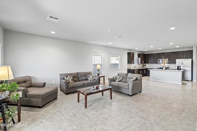 living room featuring visible vents and recessed lighting