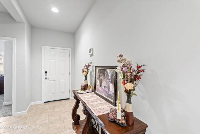 interior space featuring baseboards and light tile patterned flooring