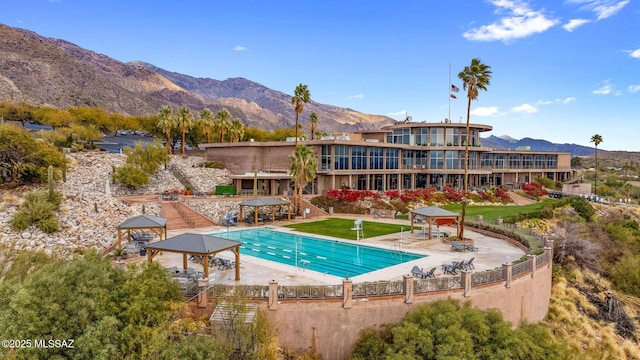 view of swimming pool with a gazebo, a mountain view, and a patio area