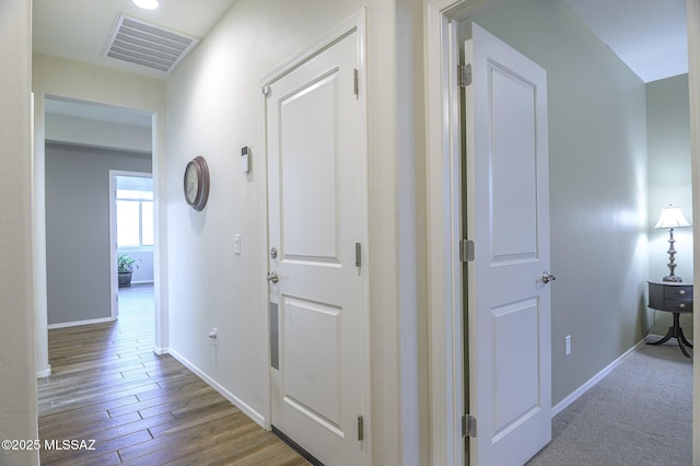 hall with hardwood / wood-style flooring