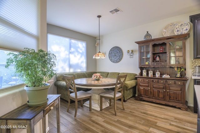 dining space with breakfast area and light hardwood / wood-style floors