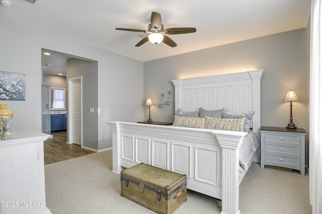 carpeted bedroom featuring connected bathroom and ceiling fan