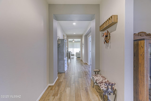 corridor with light hardwood / wood-style floors